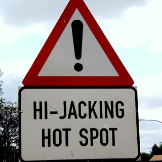 Radio Clash 83: The World Cup O’ Rock (With Guest Hosts Lee & Jeb) eclectic music mashup podcast cover sign saying Hi-Jacking Hot Spot