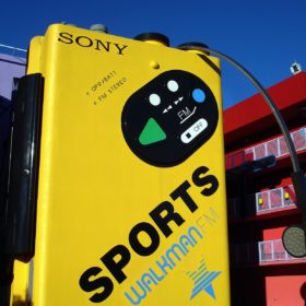 Radio Clash 87: That 1980s Show 80's eclectic music mashup podcast cover photo by Daryl Mitchell CC of a giant yellow sports Sony Walkman