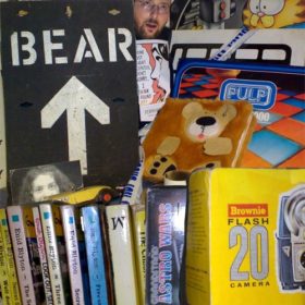 RC 141: Odds n’ Sods and Autoeroticmobiles eclectic music mashup podcast  cover shows my childhood room with Bear sign and toys and books.