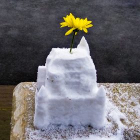 RC 280: Broken Springs, Black Holes & Snowcastles snow and weather based music and mashup podcast  cover art - image is a snow castle with a flower in it taken on the Queen's Promenade, Surbiton, UK