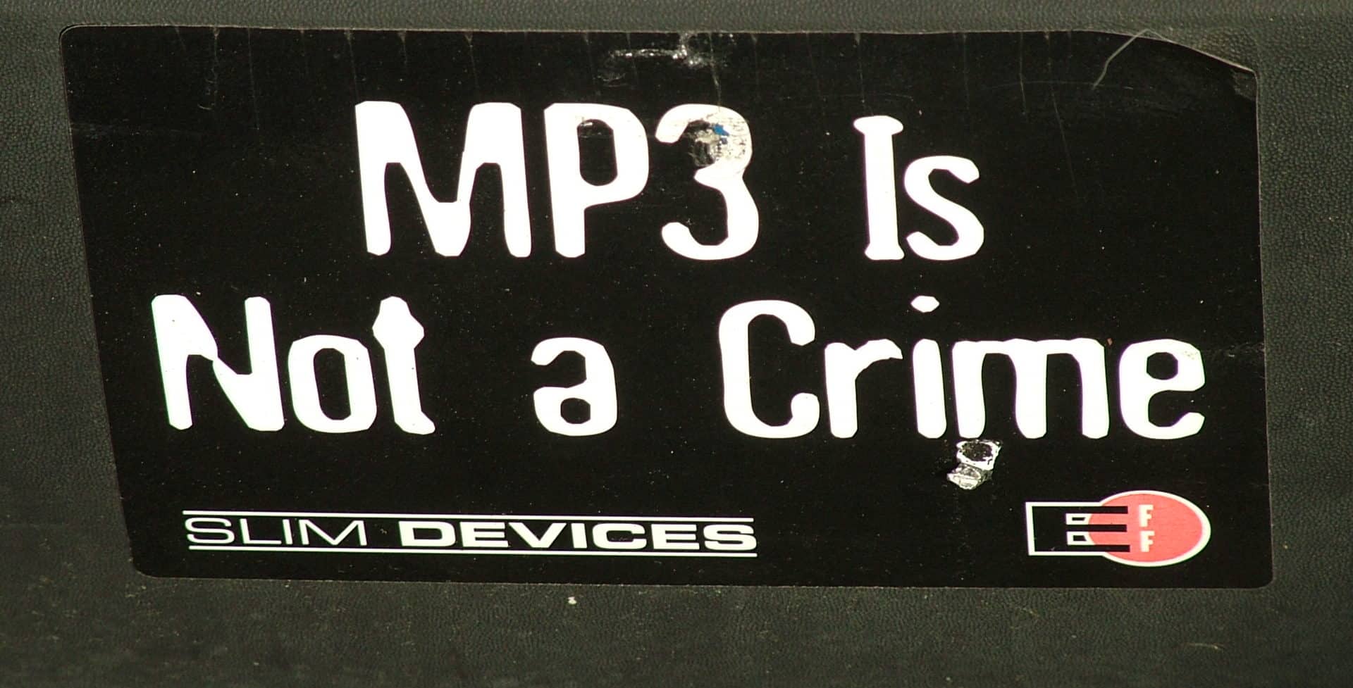 Anti-anti-piracy sticker on a laptop saying 'MP3 IS NOT A CRIME' But encoding in Joint or Mid-Side Stereo is! Photo by Tara Hunt https://www.flickr.com/photos/missrogue/90111457 Creative Commons